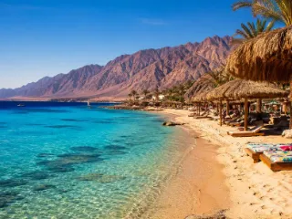 Clear Gulf of Aqaba water below red Sinai mountains at Dahab