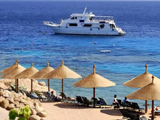 A white boat anchored off a Sharm El Sheikh beach