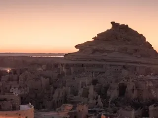 The mud-brick ruins of the Shali fortress at Siwa Oasis at dusk
