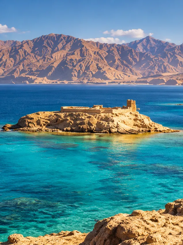 Pharaoh's Island and its citadel in the Gulf of Aqaba off Taba, with mountains across the water
