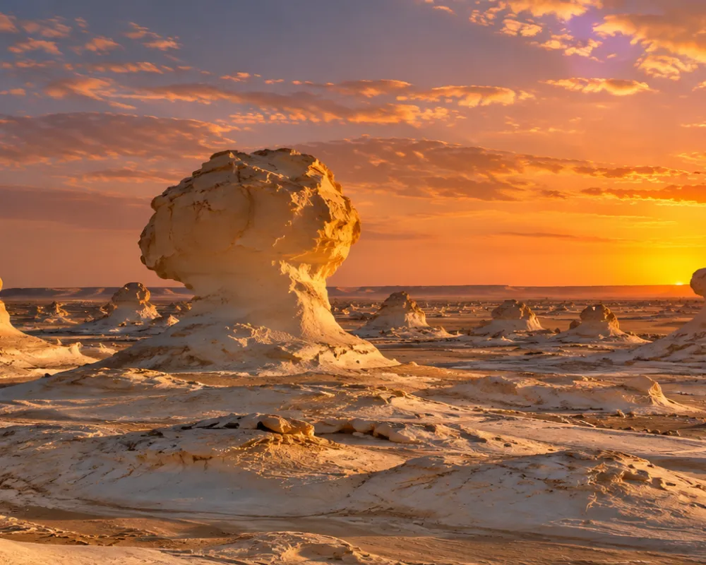 Wind-carved chalk formations of the White Desert at sunset