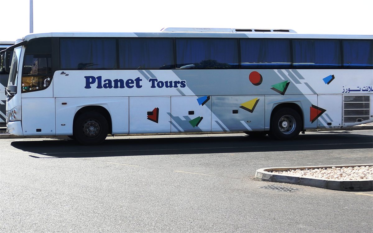 A full-size coach in a parking area