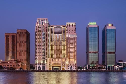 The St. Regis Cairo towers on the Nile corniche at dusk