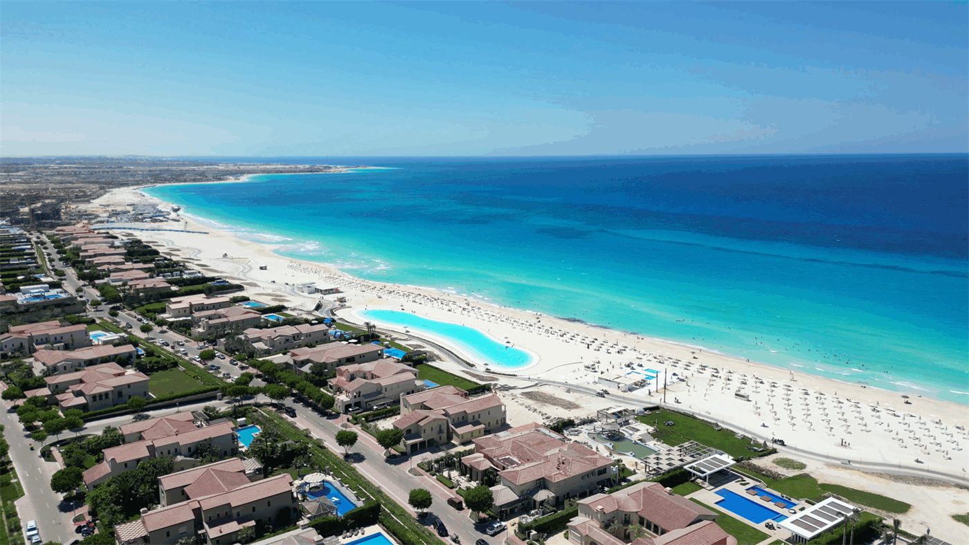 An aerial view of a white-sand Mediterranean beach and turquoise water on Egypt's North Coast