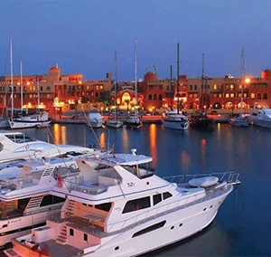 Motor yachts moored at dusk in a Red Sea marina